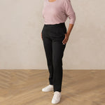 woman wearing a dark grey tailored pants with white sneakers