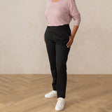 woman wearing a dark grey tailored pants with white sneakers