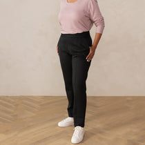 woman wearing a dark grey tailored pants with white sneakers