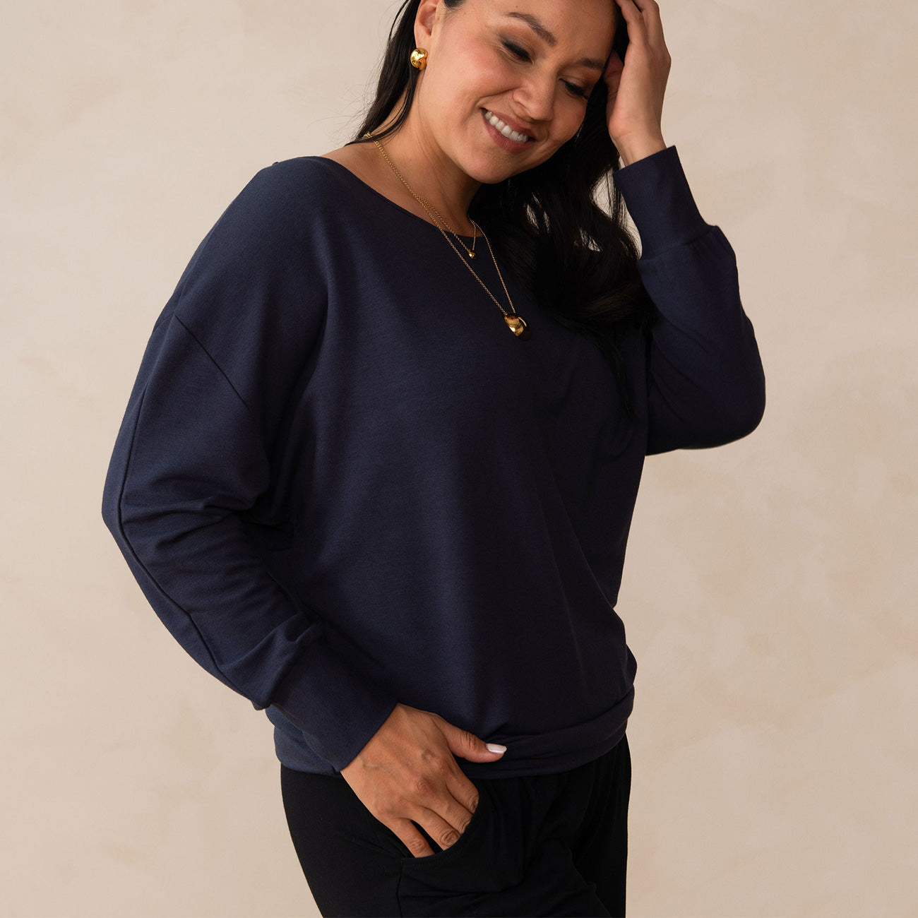 woman wearing a navy long sleeve sweatshirt