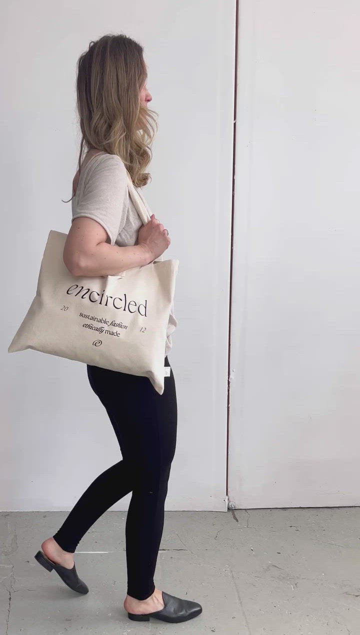 Cream coloured rectangular fabric tote bag with Encircled branding