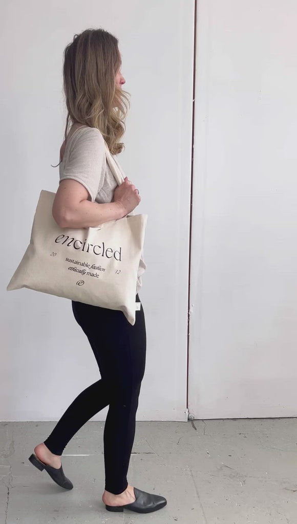 Cream coloured rectangular fabric tote bag with Encircled branding